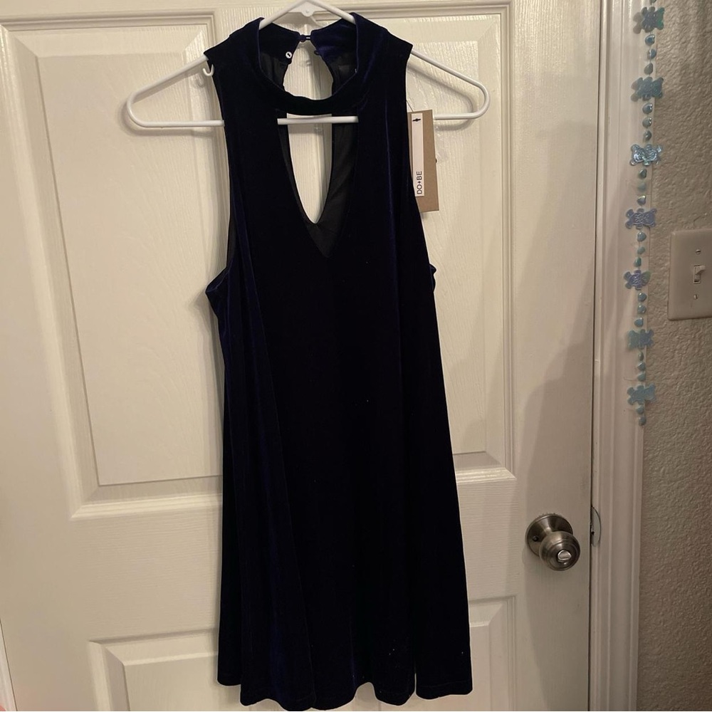 Navy blue velvet dress with a cut out in the back and a button clasp on back